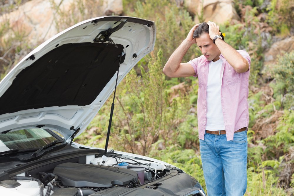 stressed-man-looking-at-engine-of-his-car